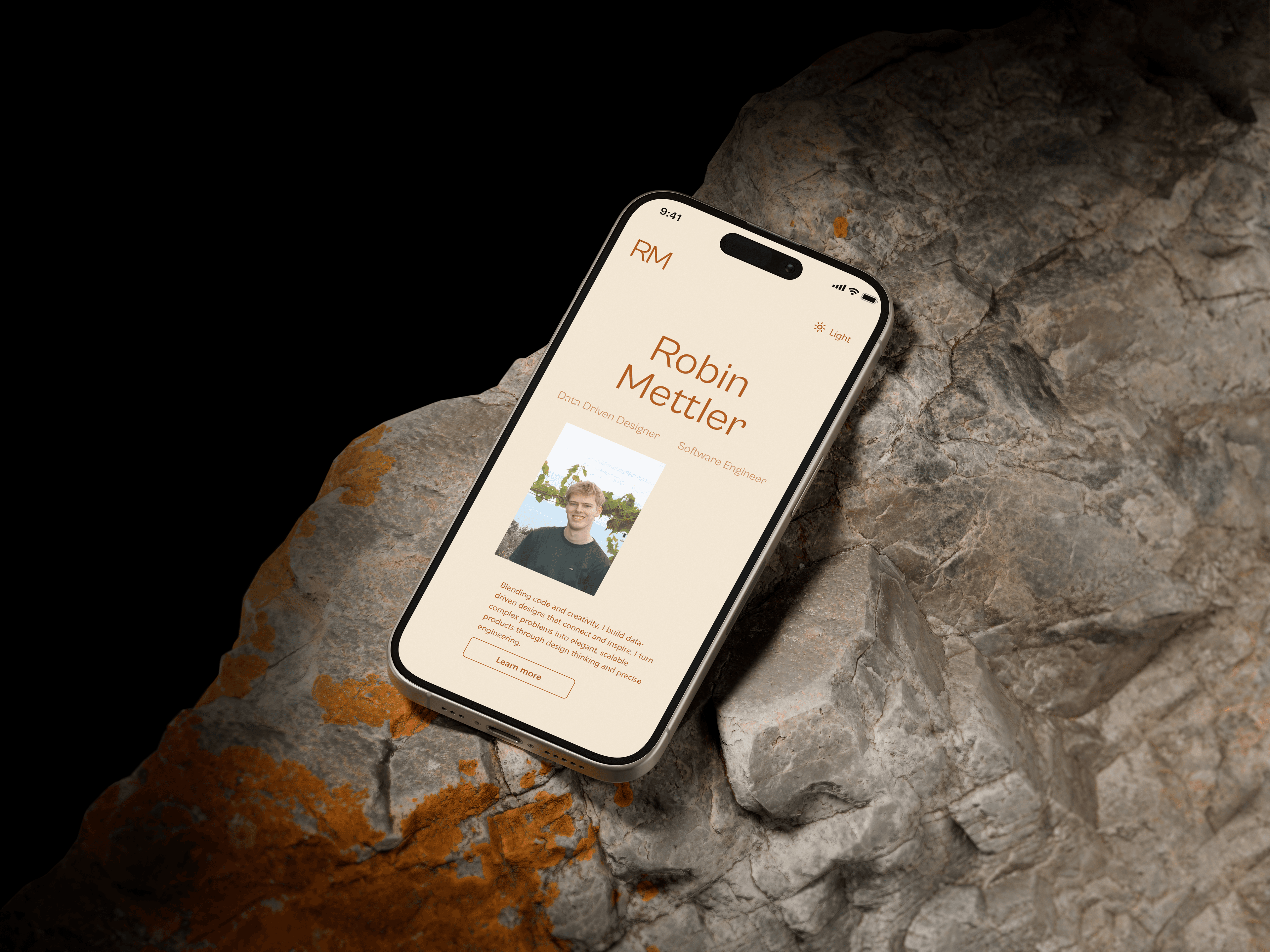 A phone displaying this portfolio website